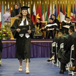 female student walking with her diploma