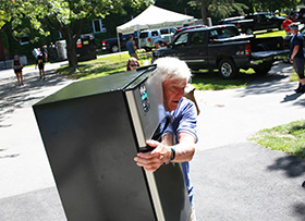 Michael Cunniff carrying a minifridge
