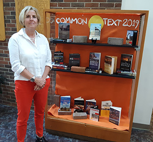Laura Crain next to display case 