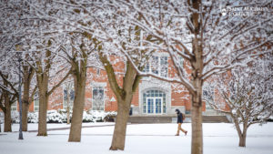 Student walking through the snow at Saint Michael's College