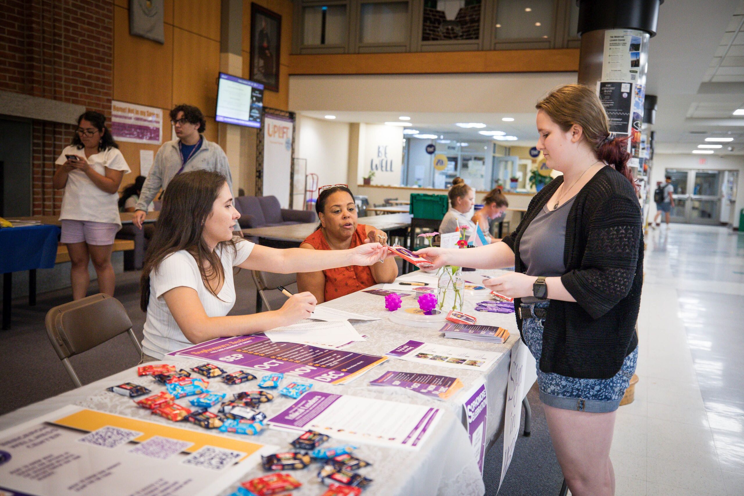 Office of Purposeful Learning Student Success Advisors Katie Barry, left, and Vernita Weller, center, speak to a student during the inaugural 