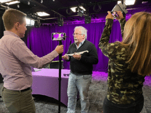 Saint Michael's College Professor Alain Brizard is filmed by a crew from MyNBC5. 