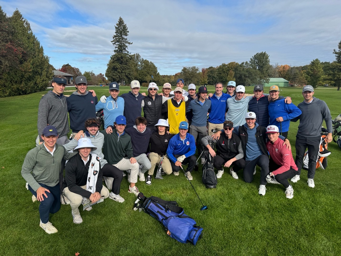 Members of the Saint Michael's College men's ice hockey team pose together during a golf outing.