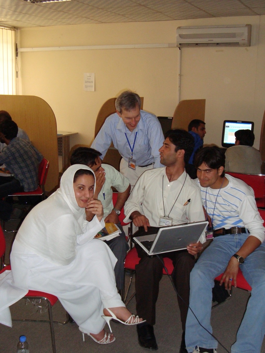 a professor talking with a group of students