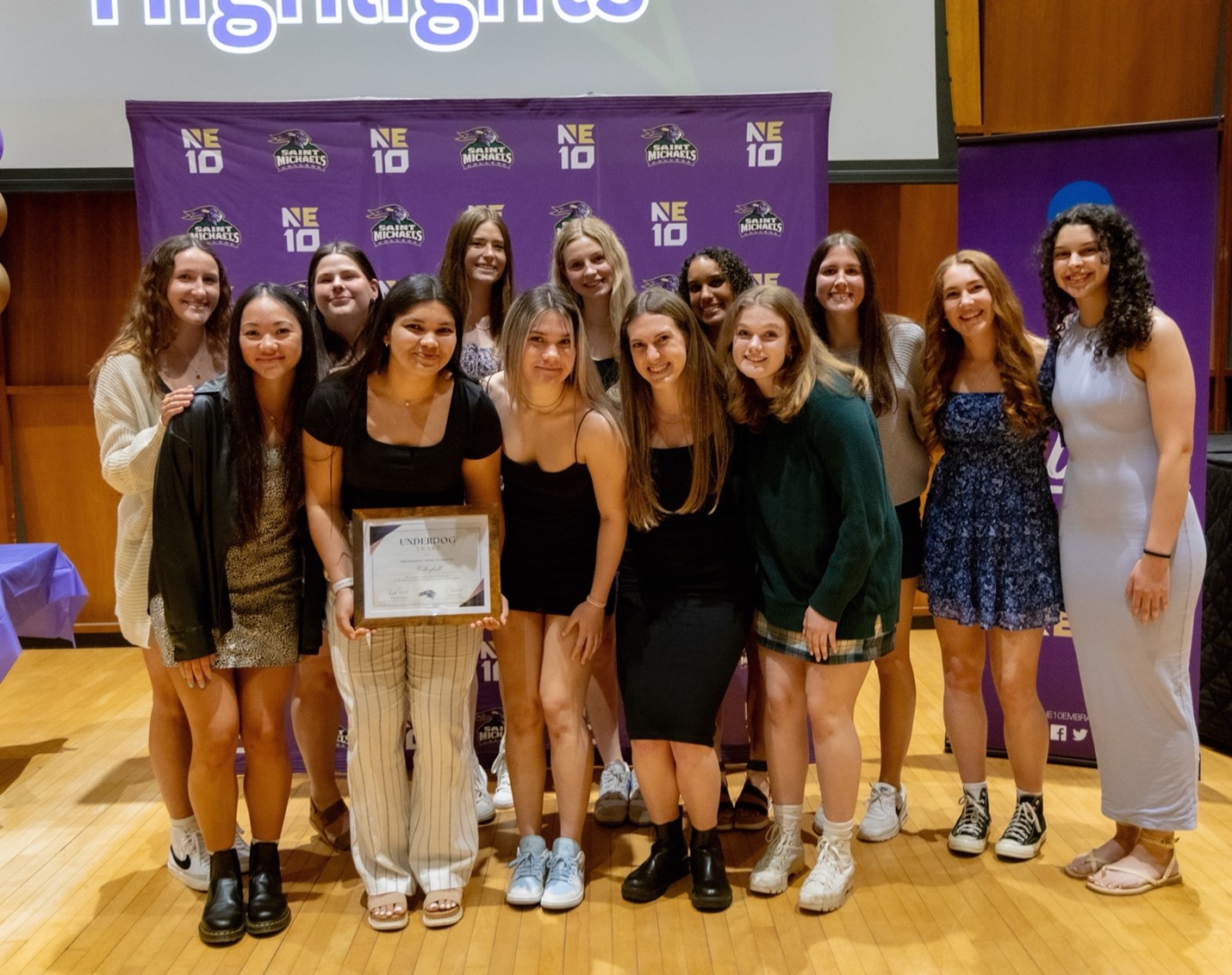 Dana Welch, fourth from the left, poses with her Saint Michael's volleyball teammates after earning an award.
