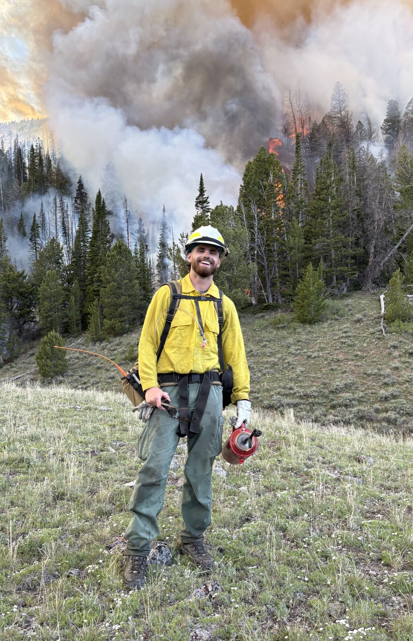 Ben Mogensen ’24 of the U.S. Forest Service in front of Wino Basin prescribed burn in Custer County, Idaho