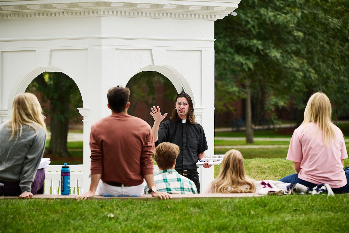 Fr. Michael Carter teaches a class in front of the cupola in the heart of campus