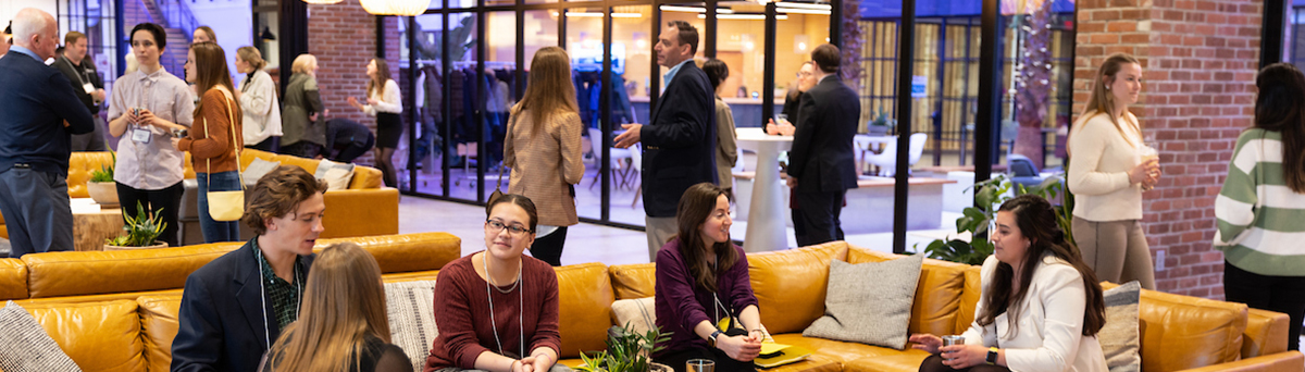 alumni and current students converse at a networking event