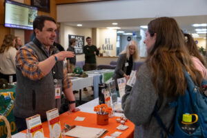 A Saint Michael's College student speaks to an alumni prospective employer during the career fair portion of Career Connections in Alliot Hall in 2025. 
