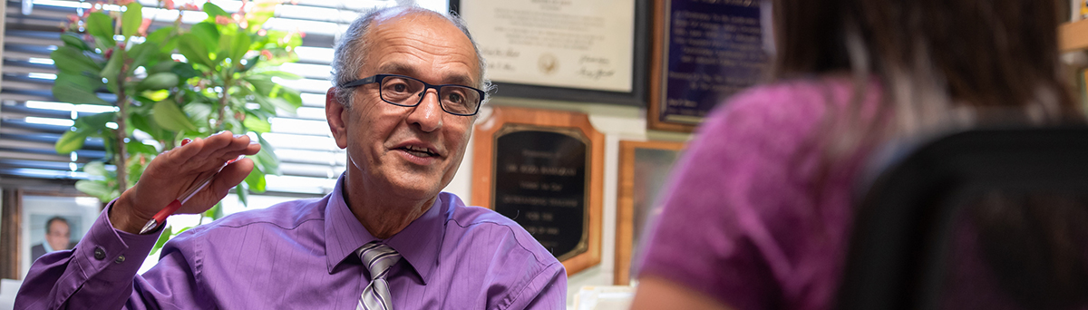 faculty member advising a student in his office