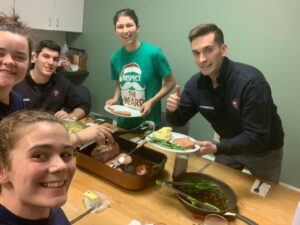 Saint Michael's Fire and Rescue members pose before eating a meal together in the kitchen of the fire and rescue station.