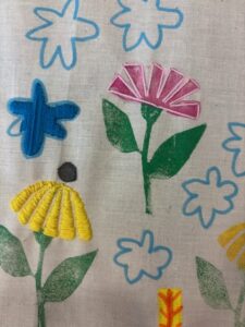 Embroidered flowers on a decorated cloth.