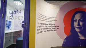 A recording booth next to a wall with a quote inside the traveling museum, People of Hope. 