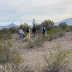 Saint Michael's College students follow artist and activist Alviro Enciso to place a cross where a migrant died while crossing the border from Mexico to Arizona.