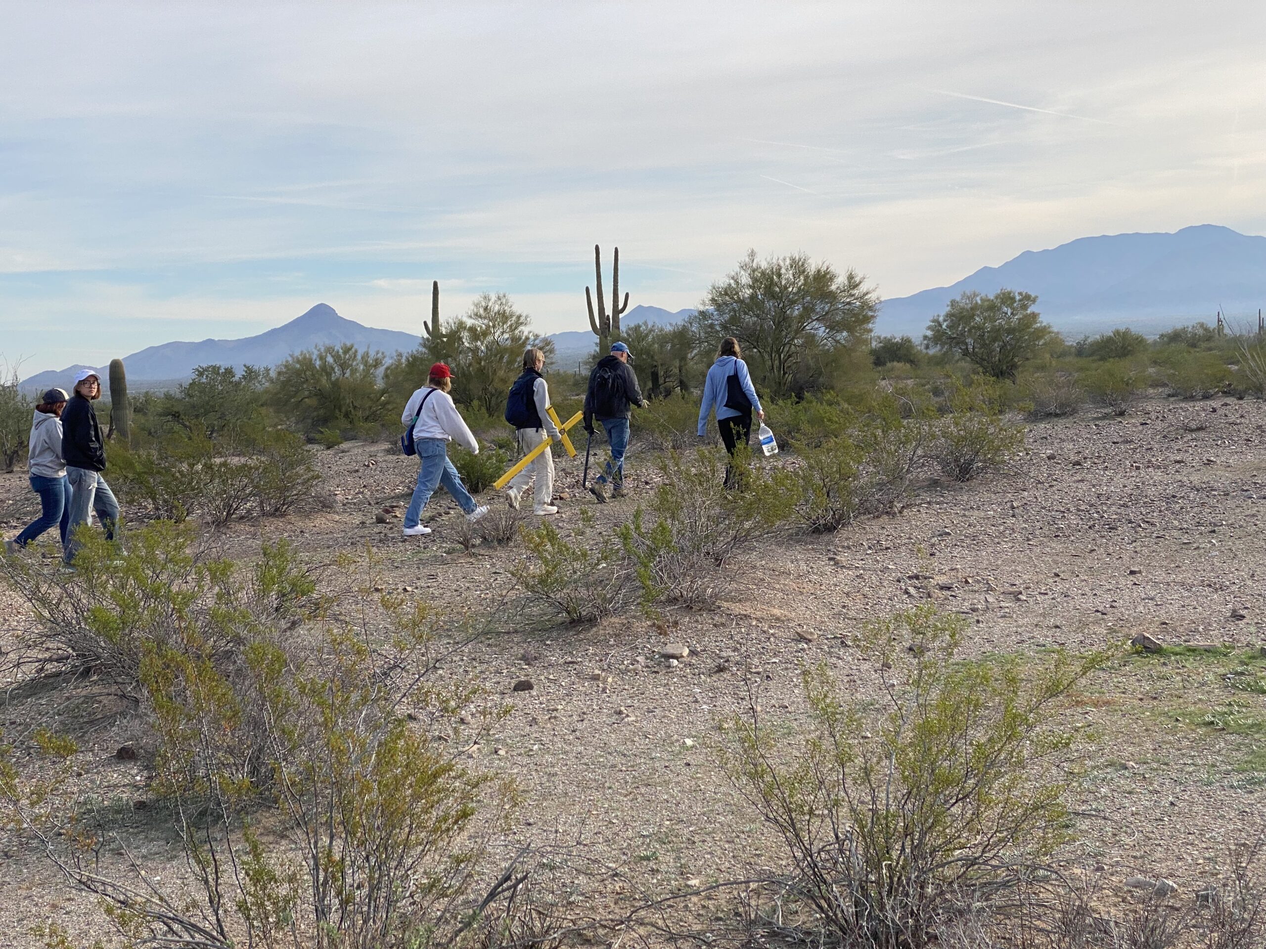 Saint Michael's College students follow artist and activist Alviro Enciso to place a cross where a migrant died while crossing the border from Mexico to Arizona.