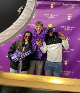 Matthew MacDonald (center) was already making friends at Saint Michael’s College, just a couple weeks after being awarded the Saint Michael’s College & WCAX Service Scholarship. The Saint Johnsbury Academy senior attended Admitted Student Weekend at St. Mike’s in March 2026, where he and new pals donned props and took Photo Booth pics. Photo courtesy Matthew MacDonald.
