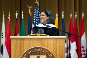 An Afghan woman gives a speech at a podium. 