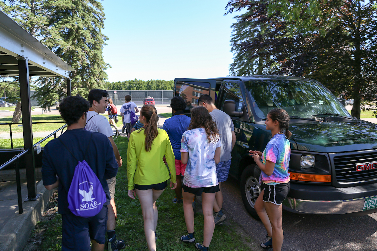Students attending SOAR head to a van for an off site trip.