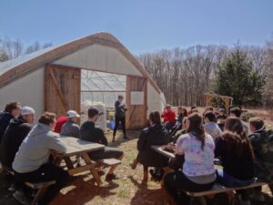 Kristyn teaching a class in front of the Hoop House on the Farm at SMC