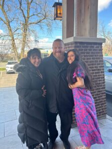 A young woman poses with her parents